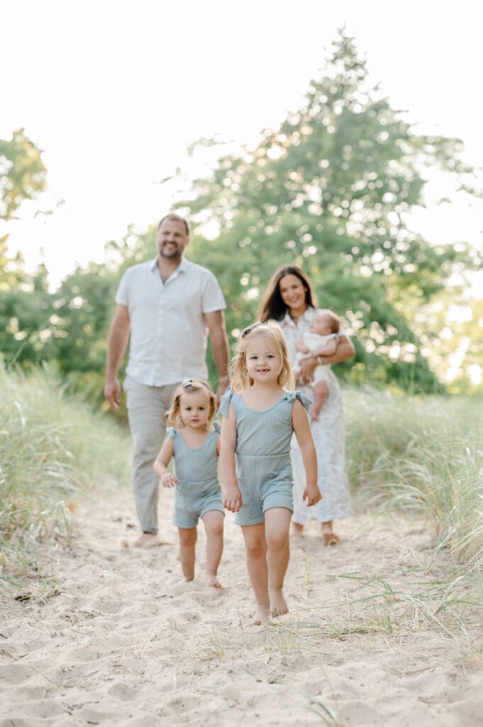 Family or four playing at the beach; why hire a professional photographer