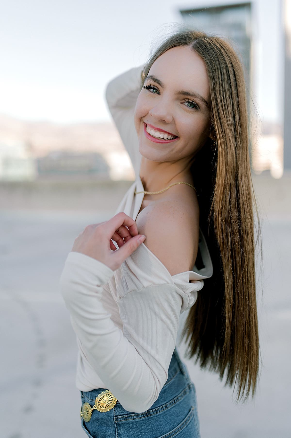 cute senior in white top smiling at camera with Heidi Burton Photography