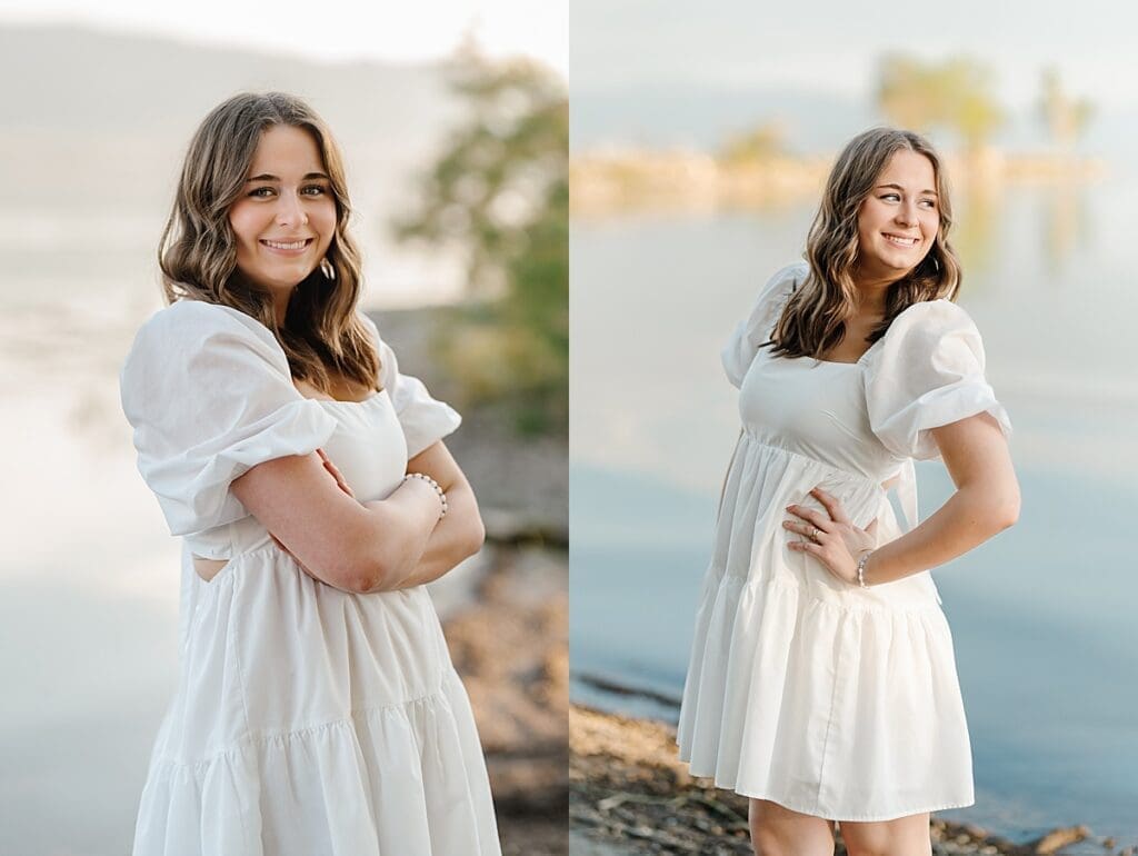 senior girl in white dress smiles in front of Utah Lake